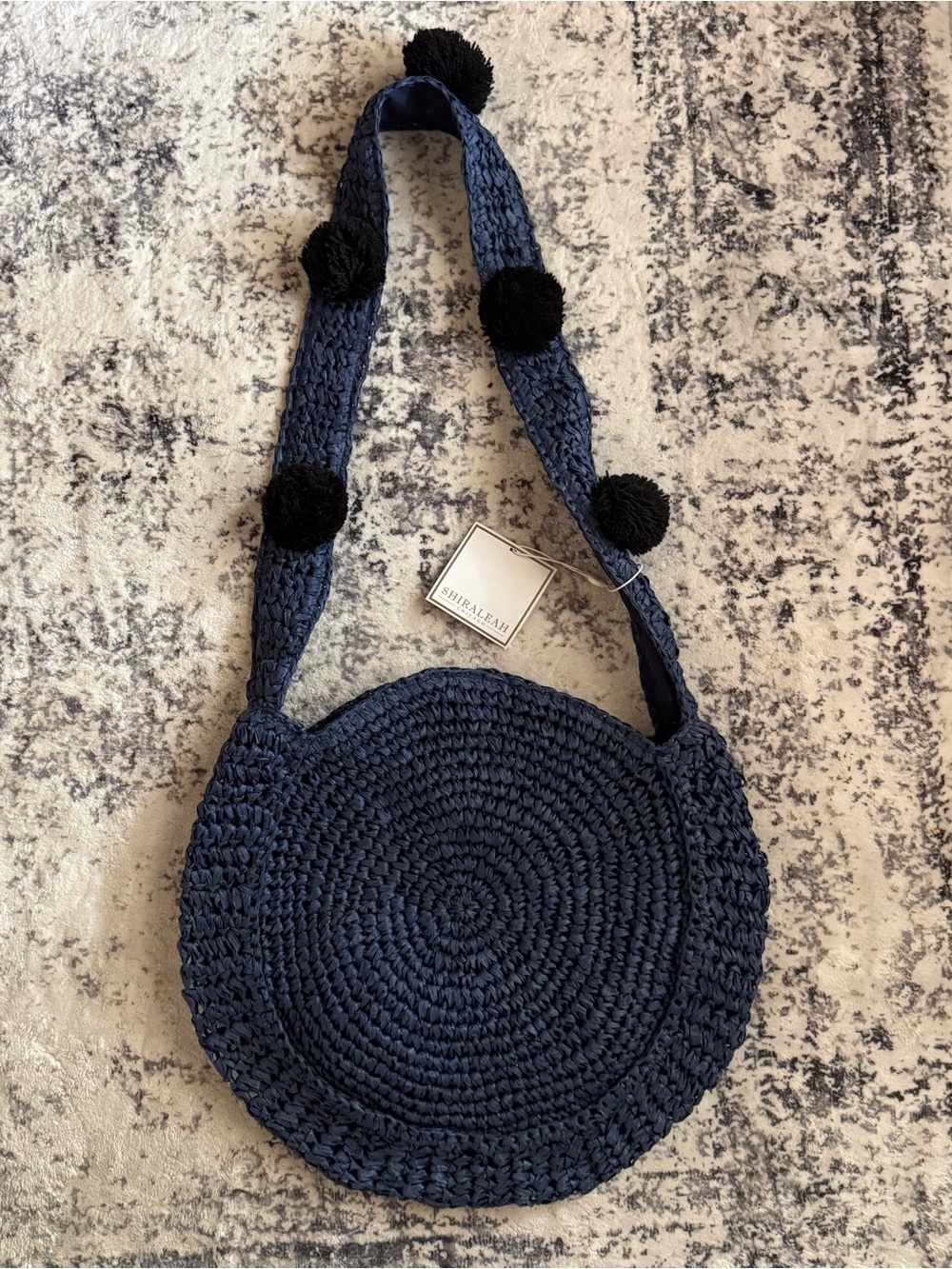 Shiraleah Navy Round Woven Crossbody with Pom-Pom Strap